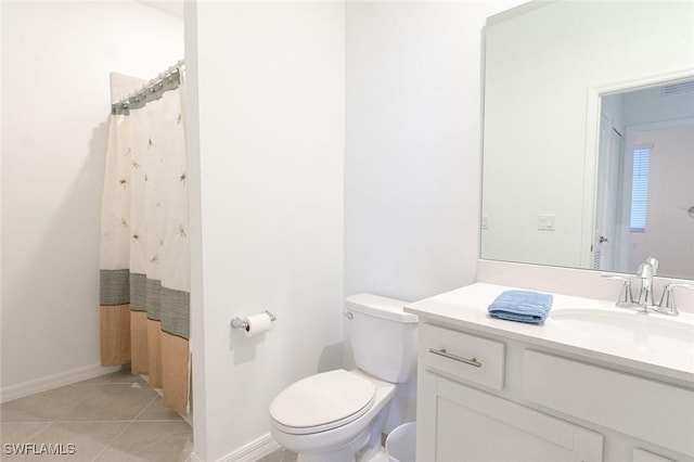 bathroom featuring toilet, vanity, tile patterned floors, and a shower with shower curtain