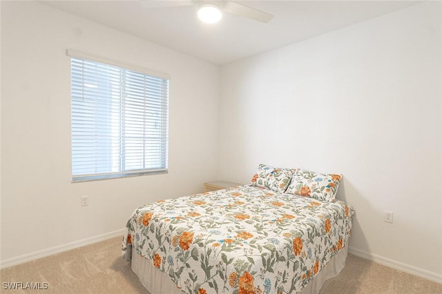 bedroom with light carpet and ceiling fan