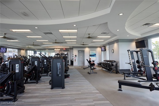 exercise room with a paneled ceiling and light carpet