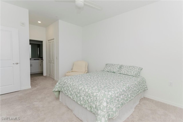 carpeted bedroom with ceiling fan, ensuite bathroom, and a closet