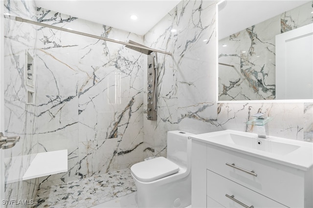 bathroom with vanity, toilet, tile walls, and a tile shower