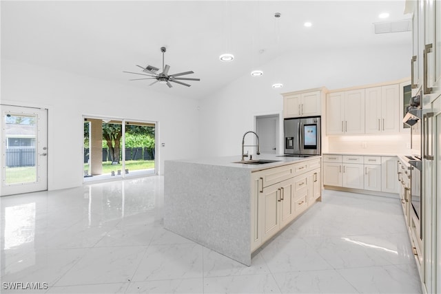 kitchen featuring sink, an island with sink, ceiling fan, stainless steel refrigerator with ice dispenser, and lofted ceiling