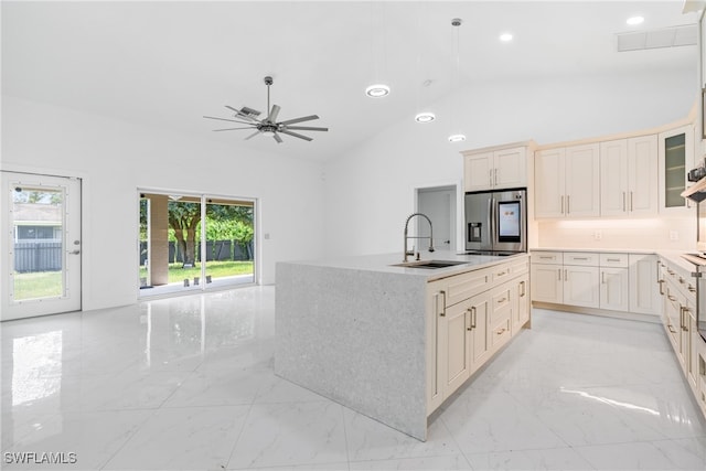 kitchen with stainless steel fridge with ice dispenser, a kitchen island with sink, sink, high vaulted ceiling, and ceiling fan