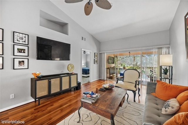 living room with ceiling fan, wood-type flooring, and high vaulted ceiling