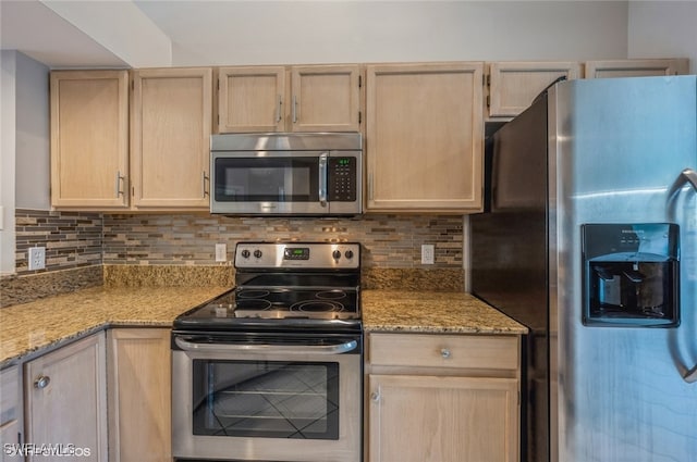 kitchen featuring stainless steel appliances, light brown cabinetry, light stone counters, and tasteful backsplash