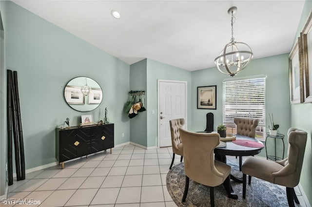 dining room featuring a notable chandelier, baseboards, and light tile patterned floors