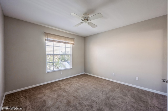 carpeted empty room with baseboards and a ceiling fan