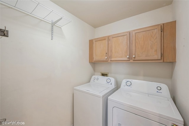 laundry room with cabinets and washer and dryer