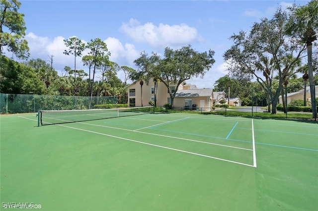 view of tennis court featuring fence