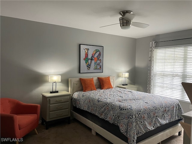 bedroom featuring ceiling fan and dark colored carpet