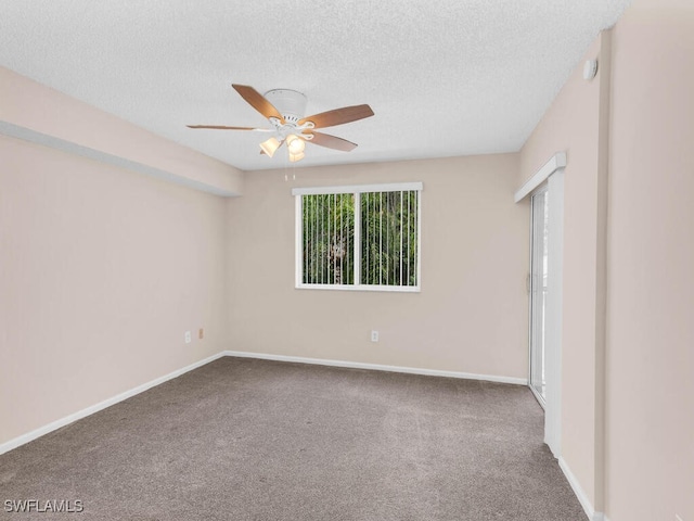 carpeted spare room featuring a textured ceiling and ceiling fan