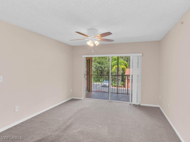 carpeted spare room featuring a textured ceiling and ceiling fan