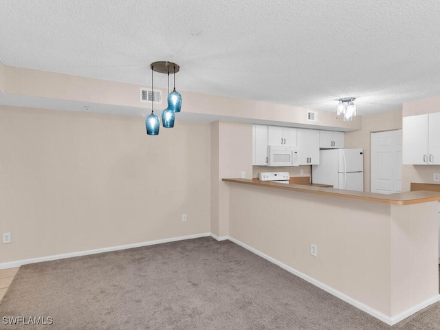 kitchen with a textured ceiling, white appliances, pendant lighting, kitchen peninsula, and white cabinets