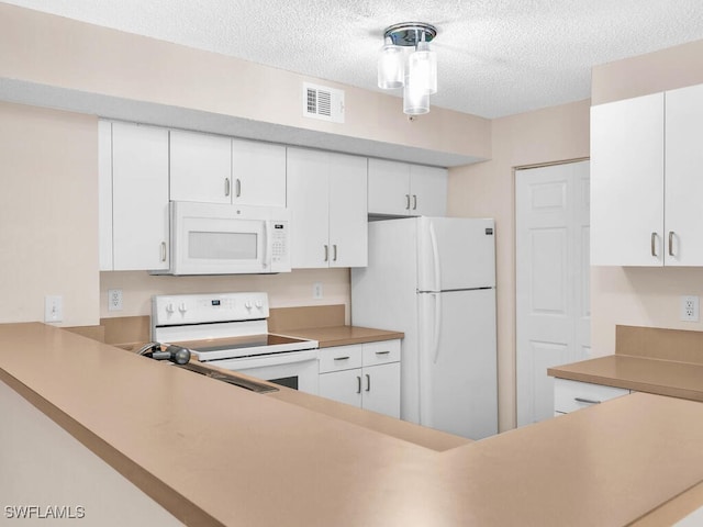 kitchen featuring white cabinets, white appliances, sink, and a textured ceiling