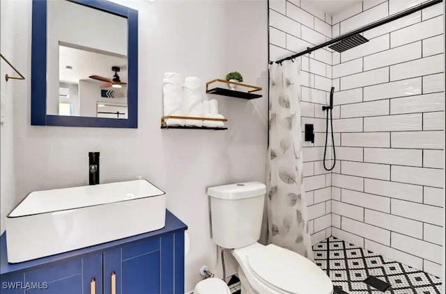1797 42nd Ter SW, Naples, FL 34116 - bathroom with a tile shower, toilet, ceiling fan, and vanity
