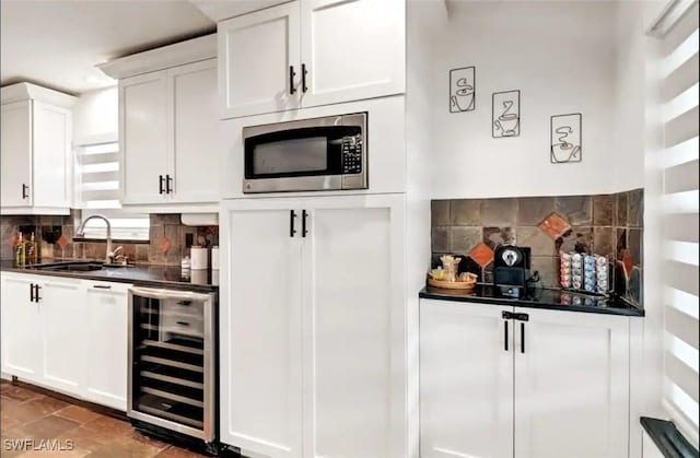1797 42nd Ter SW, Naples, FL 34116 - bar area with wine cooler, stainless steel microwave, a sink, and decorative backsplash