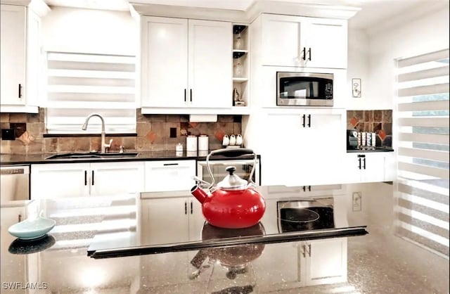 1797 42nd Ter SW, Naples, FL 34116 - kitchen with stainless steel microwave, a sink, open shelves, and decorative backsplash