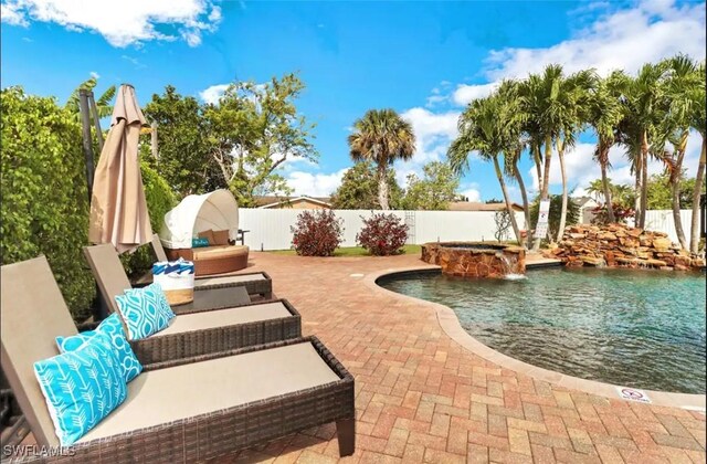 1797 42nd Ter SW, Naples, FL 34116 - view of pool with a fenced backyard, a patio, a pool with connected hot tub, and an outdoor hangout area