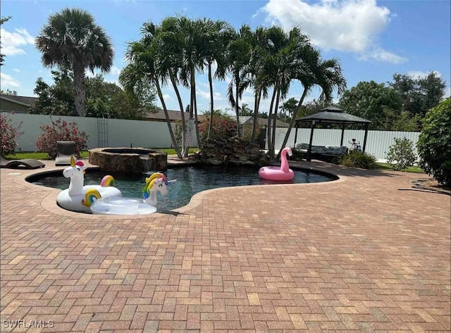 1797 42nd Ter SW, Naples, FL 34116 - view of swimming pool featuring a gazebo, a fenced backyard, a pool with connected hot tub, and a patio