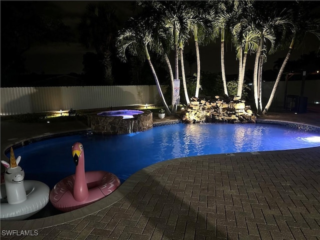 1797 42nd Ter SW, Naples, FL 34116 - pool at night featuring fence, a patio, and a pool with connected hot tub
