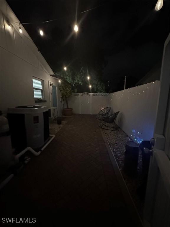 1797 42nd Ter SW, Naples, FL 34116 - yard at night featuring central air condition unit and fence