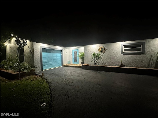 1797 42nd Ter SW, Naples, FL 34116 - view of front facade with stucco siding, an attached garage, and asphalt driveway