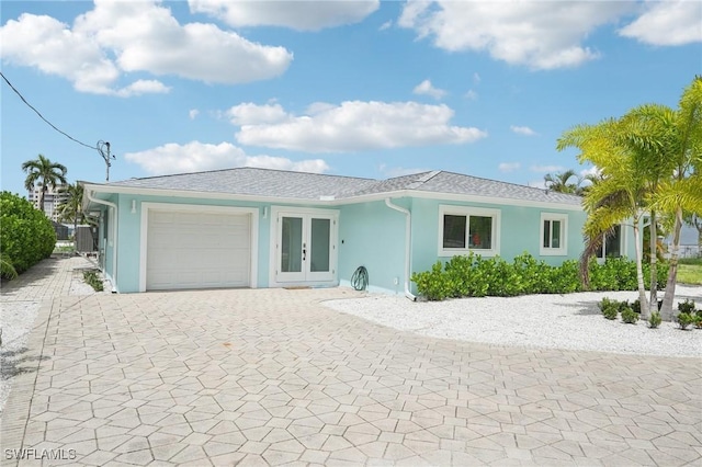 8339 Estero Blvd, Fort Myers Beach, FL 33931 - ranch-style home featuring stucco siding, french doors, decorative driveway, and a garage