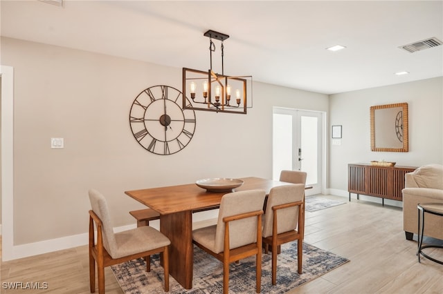 dining room with an inviting chandelier and light hardwood / wood-style floors