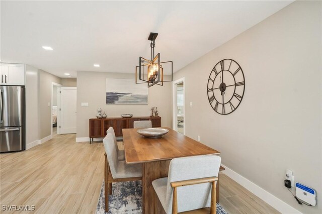 8339 Estero Blvd, Fort Myers Beach, FL 33931 - dining space featuring recessed lighting, an inviting chandelier, baseboards, and light wood-style floors
