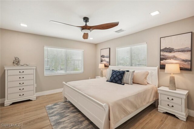 bedroom with light wood-type flooring and ceiling fan