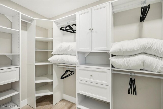 spacious closet featuring light hardwood / wood-style floors