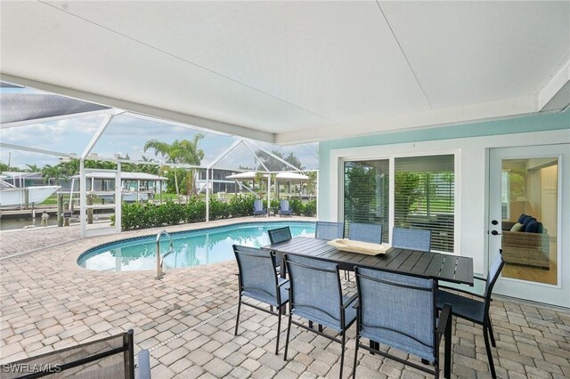 view of swimming pool with a lanai and a patio