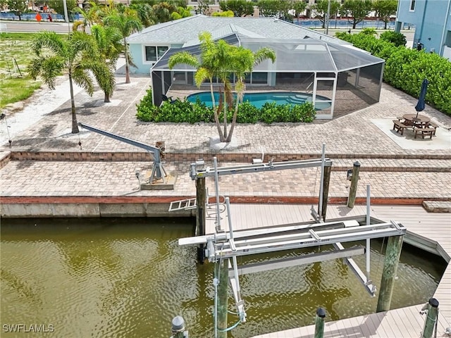 8339 Estero Blvd, Fort Myers Beach, FL 33931 - dock area with an outdoor pool, glass enclosure, a water view, and boat lift