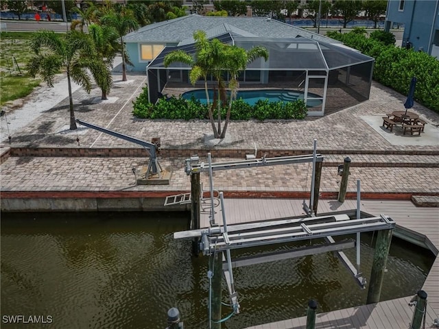 8339 Estero Blvd, Fort Myers Beach, FL 33931 - dock area with a water view, glass enclosure, boat lift, an outdoor pool, and a patio