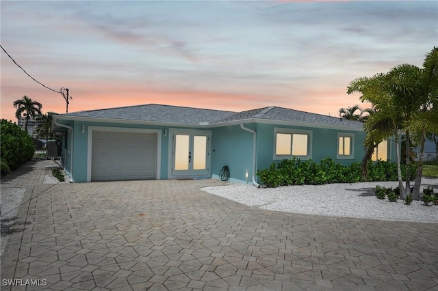 8339 Estero Blvd, Fort Myers Beach, FL 33931 - ranch-style house featuring stucco siding, a shingled roof, decorative driveway, and a garage