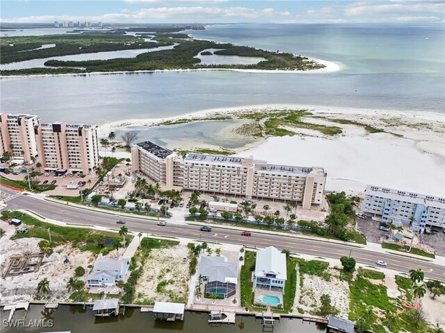 birds eye view of property with a view of the beach and a water view