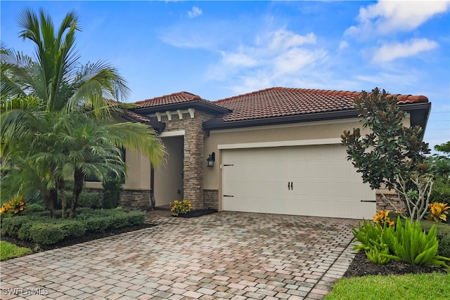 mediterranean / spanish house with a garage