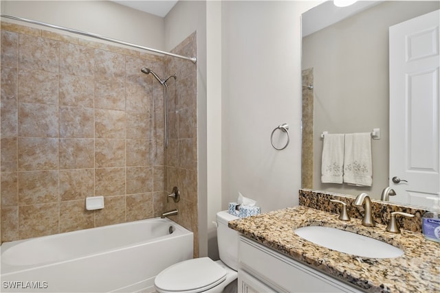 full bathroom with toilet, tiled shower / bath combo, and vanity