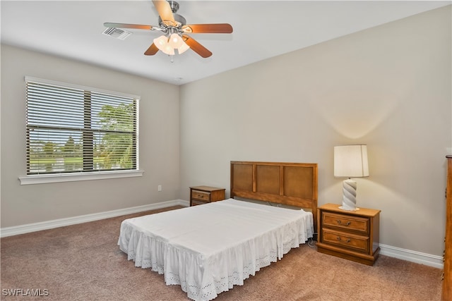 bedroom featuring ceiling fan and light carpet