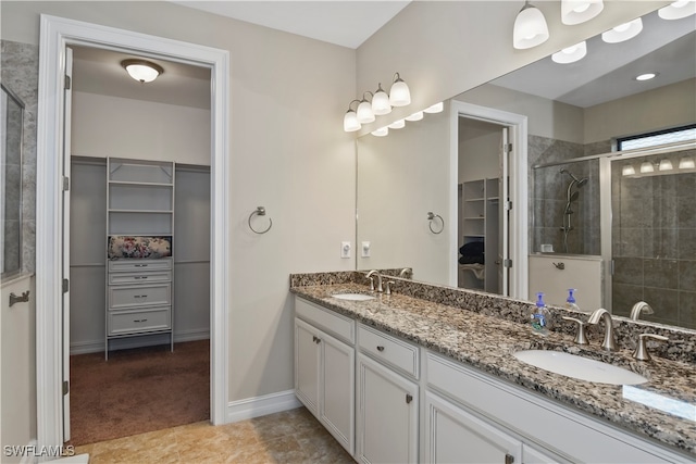 bathroom with a shower with shower door and vanity