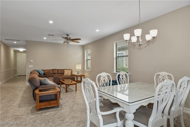 dining space featuring ceiling fan with notable chandelier and light tile patterned flooring