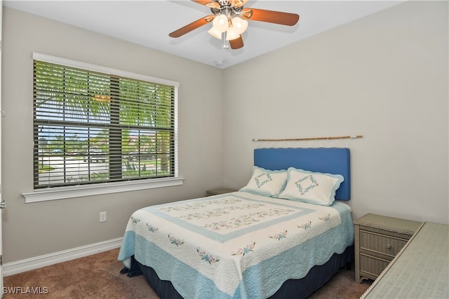 bedroom featuring ceiling fan and dark colored carpet