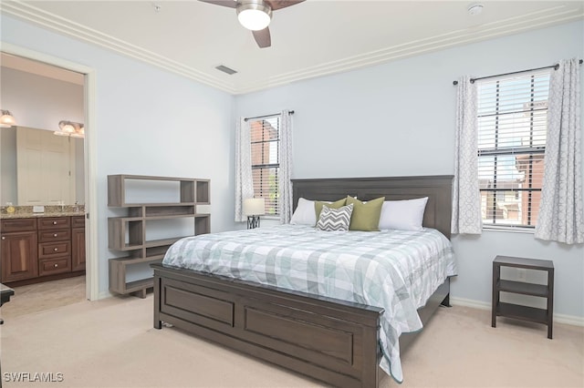 carpeted bedroom featuring ensuite bath, ceiling fan, and crown molding