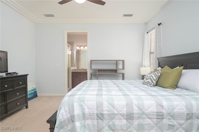 carpeted bedroom with crown molding, ensuite bath, and ceiling fan