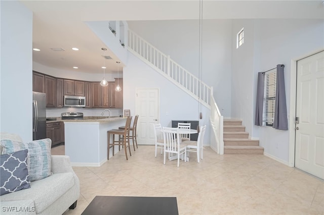 living room with a high ceiling and sink