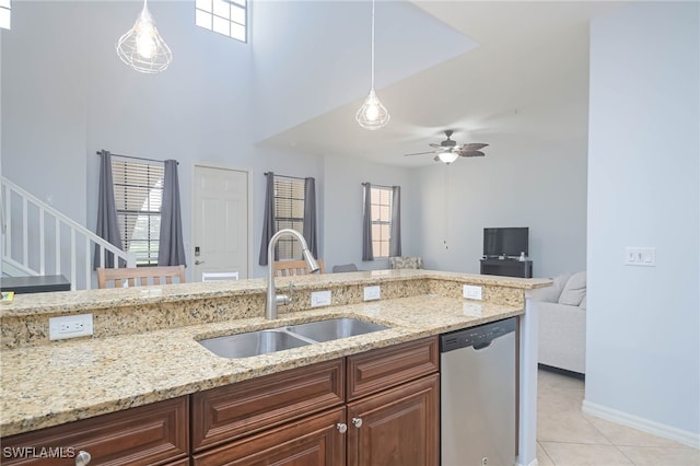 kitchen featuring dishwasher, decorative light fixtures, and a healthy amount of sunlight