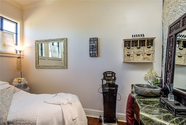 bedroom with ornamental molding and hardwood / wood-style flooring