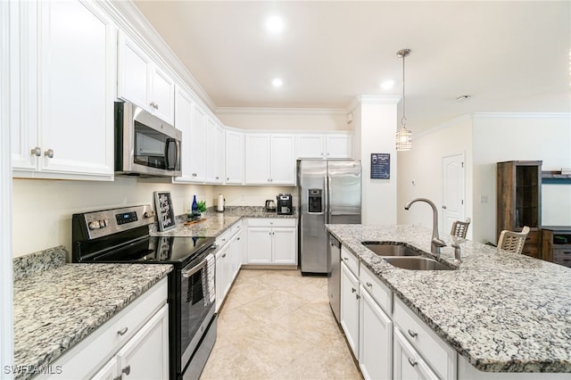 kitchen featuring a kitchen island with sink, stainless steel appliances, a sink, white cabinets, and crown molding