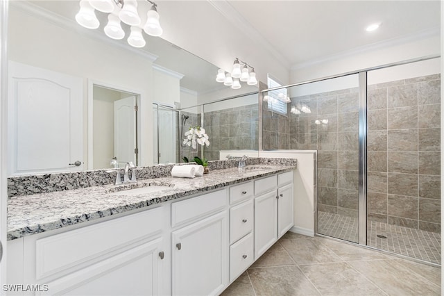 bathroom featuring a shower stall, ornamental molding, and a sink