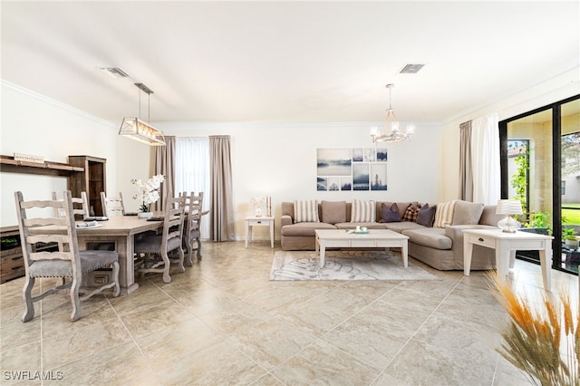 living area with a chandelier, crown molding, and a healthy amount of sunlight